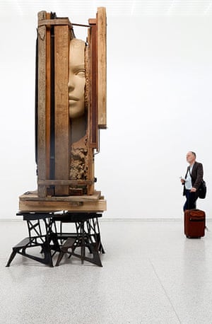 Venice biennale: A visitor looks at the installation Working Table by Mark Manders in the Du