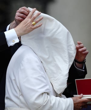 Hate it when this happens! A gust of wind lifts Pope Francis' pellegrina over his face during his weekly general audience in St Peter's Square at the Vatican.