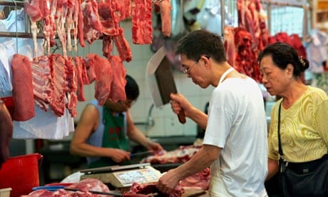 A Chinese vendor sells pork in a Hong Kong market
