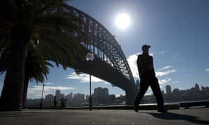 A man walks near the Sydney Harbour Bridge. The landmark bridge is to undergo its biggest makeover since 1932, with a new coat of paint that will take two years to complete, the New South Wales state government has announced.