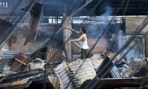 A man begins to clean up a burnt down market after riots broke out in Lashio, in eastern Burma's Shan state. Security forces patrolled the riot-scarred streets of the town after a fresh outbreak of religious violence that left one dead and several wounded.