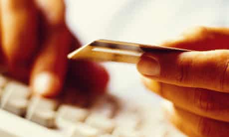 Man shopping on internet, entering credit card number