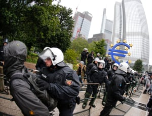 German police officers takes away a demonstrator during a demonstration of some hundred anti-capitalism Blockupy protesters in front of the European Central Bank in Frankfurt, Friday, May 31, 2013.