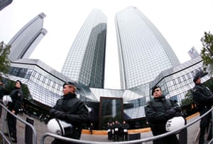 German police officers guard the Deutsche Bank building during a demonstration of some hundred anit-capitalism Blockupy protesters in front of the European Central Bank in Frankfurt, Friday, May 31, 2013.