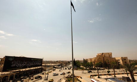 The flag of the Islamist rebel group Jabhat al-Nusra flies over the main square of the city of Raqqa