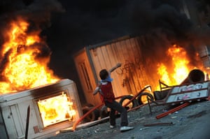 Rioting in Turkey: A protestor throws stones