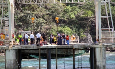 Australian authorities assist asylum seekers who survived their vessel capsizing off Christmas Island, on Sunday.