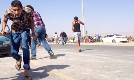 File picture of protesters running for cover after Libya Shield militia opened fire on 8 June