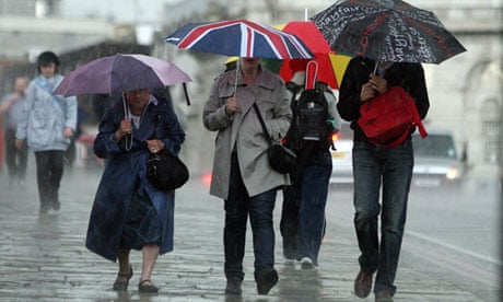 People walk through wind and rain in London