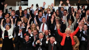Back to business at the G8 Summit...guests including Northern Ireland's Chief Constable Matt Baggott, front left, Lord Chief Justice Sir Declan Morgan, third left front, and Dame Mary Peters, front right, are swept up in a Mexican wave while they wait for the arrival of President Obama at the Waterfront Hall.