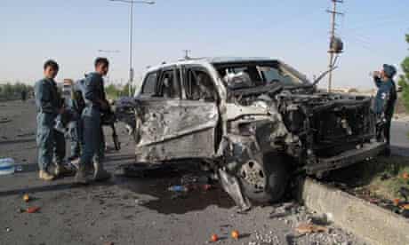 Afghan police at the scene of a car bombing in Helmand province on Monday