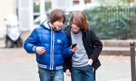 Young boys using mobile phone.