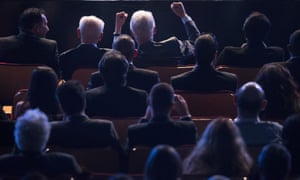 Former US President Bill Clinton lifts his hands as he watches a film about on him as he sits next to Israeli President Shimon Peres in Jerusalem. Global figures from all over the world gathered in Jerusalem to celebrate the Israeli president's 90th birthday.