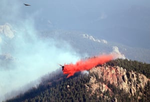A slurry bomber drops retardant on a wildfire near Pine, Colorado.