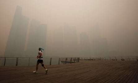 Not the nicest morning for a jog. A man runs along the deserted Marina Promenade as the skyline of Singapore's central business district covered in haze. Haze from fires in Indonesia are blanketing Singapore and could persist for weeks.
