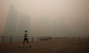 Not the nicest morning for a jog. A man runs along the deserted Marina Promenade as the skyline of Singapore's central business district covered in haze. Haze from fires in Indonesia are blanketing Singapore and could persist for weeks.
