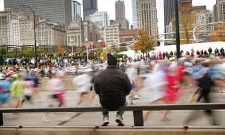 A spectator watches the start of the Chicago Marathon