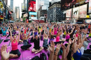 Sun salute: thousands take part in a group yoga practice on the morning of the summer solstice in New York's Times Square.