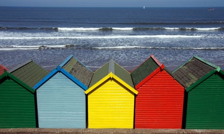 Colorful beach huts by sea