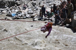 India Food: A stranded pilgrim crosses over a river by rope near Hemkunsaheb