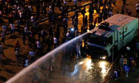 A water cannon sprays protesters during clashes in Taksim Square, Istanbul