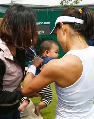 Backhand: Kimiko Date-Krumm of Japan signs her autograph on a child's t-shirt after defeating Alexandra Cadantu of Romania.