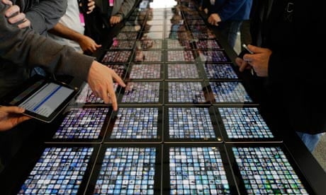 Mobile: Developers look over new apps being displayed on iPads at the Apple WWDC