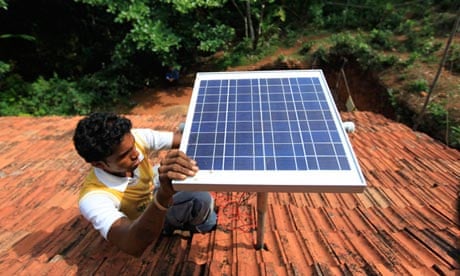 A man installs a solar panel on a roof