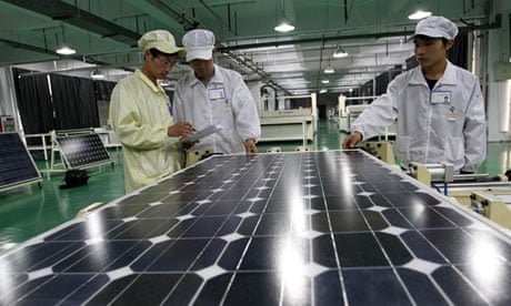 Chinese workers examine solar panels at a plant in Huaibei in China's Anhui province