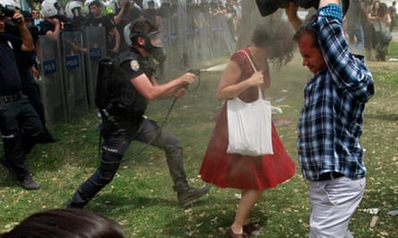 Turkish riot policeman uses tear gas against woman 4