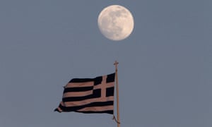 A Greek flag flutters on the top of the parliament as the moon rises in Athens May 23, 2013.