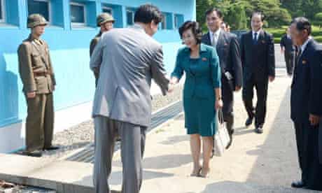 North Korean delegate Kim Song-hye, right, is greeted by a South Korean official in Panmunjom