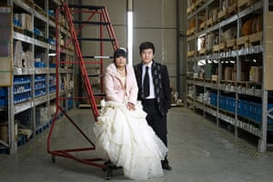 Love on the assembly line: Guang Xia and his wife Qianqian Li pose for a photo at Shanghai Ying Feng I
