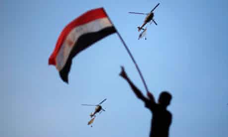 Egyptian military helicopters trailing national flags circle over Cairo during anti-Morsi protests