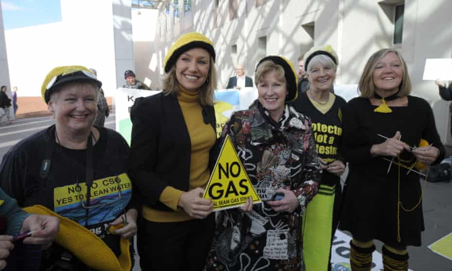 Australian Greens Senators Larissa Waters and Christine Milne pose with yellow beanies before speaking to landowners and protesters of the 'Lock the Gate' movement.