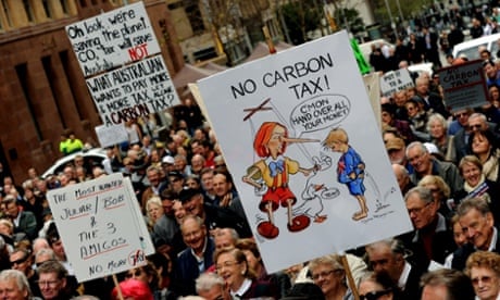 A protester holds a placard during a rally in Sydney against Julia Gillard's 'carbon tax'.