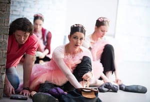 Coppelia: Dancers tie their ballet shoes on backstage