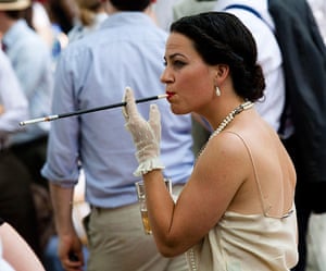 Chap Olympiad: A woman smokes a cigarette while watching the events.