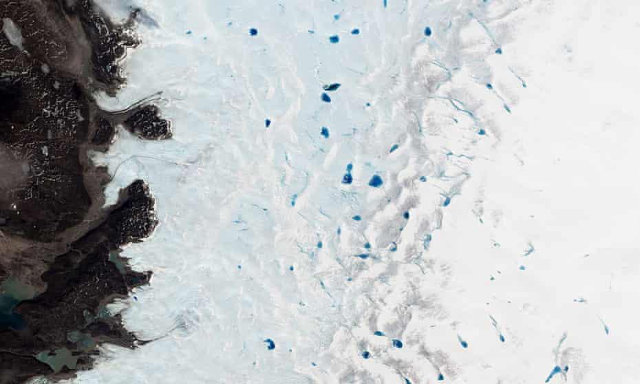 Springtime in southwest Greenland. Pools of blue water begin to dot the surface of the ice sheet as the top layer of snow and ice melts