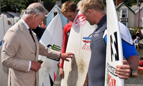 Prince Charles meets surfers in Cornwall on the day his secretary was defending his tax affairs