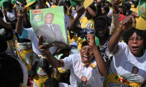 Party supporters cheer at President Robert Mugabe's campaign rally in Chitungiwiza, Zimbabwe.