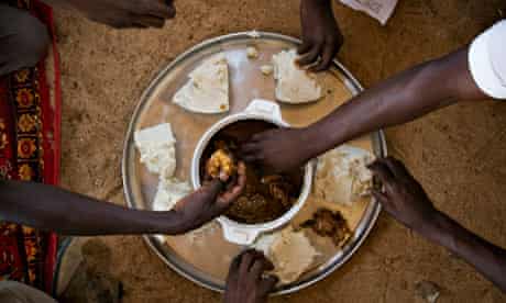 Men share a midday meal at Kerfi in eastern Chad