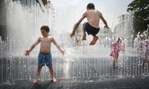 Children and their parents play in the fountains at the Southbank Centre, outside the Royal Festival Hall, London, UK.