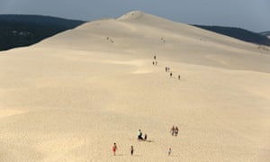 People walk on top of the Pilat dune, the highest sand dune in Europe, at La Teste-de-Buch in France.