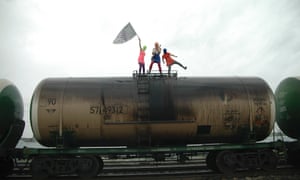 Members of the Pussy Riot punk band perform on an oil transport wagon. The band took aim at President Vladimir Putin and how he runs Russia's oil industry in its first video for almost a year.