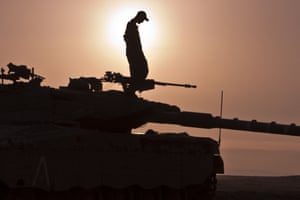 An Israeli soldier stands on top of a Merkava tank stationed in the Israeli-occupied Golan Heights, after mortar fire from inside war-torn Syria exploded in northern Golan, near the border with Syria. The apparently stray rounds struck as Syrian rebels and regime forces battled near Quneitra which lies in no-man's land, an AFP correspondent reported. Photograph: Jack Guez/AFP/Getty Images