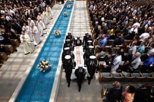 Pallbearers carrying the casket containing the body of firefighter Kevin Woyjeck leave after funeral services for Woyjeck at Christ Cathedral in Garden Grove, California. Woyjeck was among 19 firefighters who were killed while battling an Arizona wildfire on June 30.