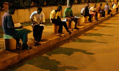 Guinean students study at G'bessi airport in the capital, Conakry