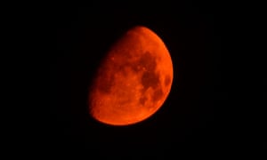 The moon appears red as it's seen through smoke in the sky over a wildfire near Idyllwild in California. The blaze erupted on Monday afternoon about 100 miles east of Los Angeles in the rugged San Jacinto Mountains.