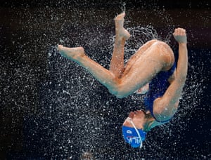 A member of the Italy team is thrown up in the air during a synchronized swimming training session ahead of the FINA Swimming World Championships in Barcelona, Spain.